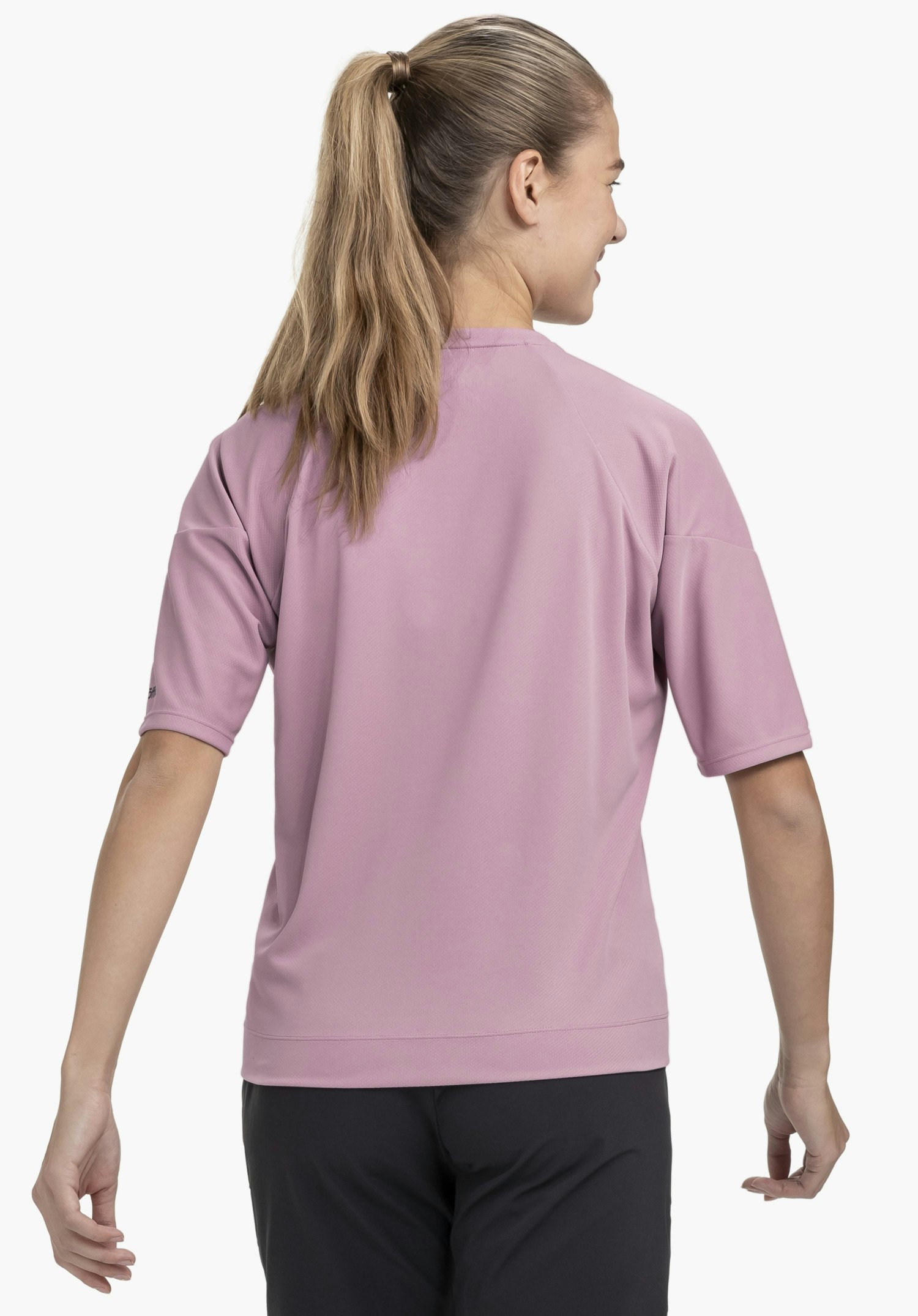 T Shirt Style Enixa WMN in der Farbe rosa in der Rückenansicht am Model vor neutralem Hintergrund, wobei das Schöffel-Logo am Ärmel sichtbar ist.