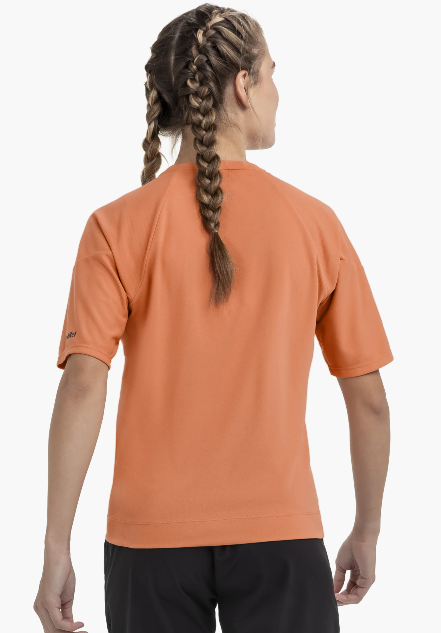 T Shirt Style Enixa WMN in orange, shown from the rear view against a neutral background, featuring the Schöffel logo on the sleeve.