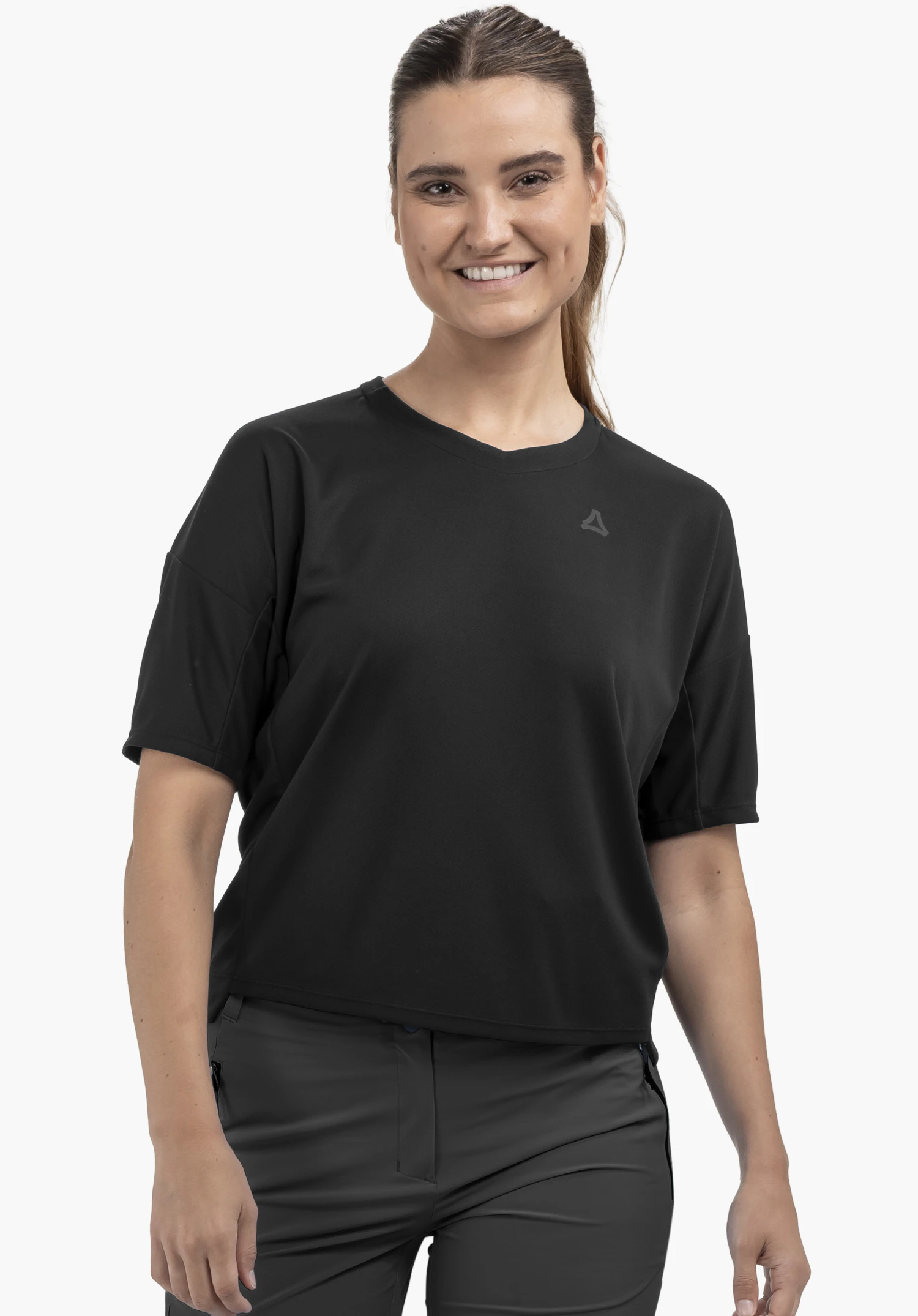T Shirt Style Enixa WMN on a model standing facing forward. The black t-shirt features a Schöffel logo on the left chest, presented against a neutral background.