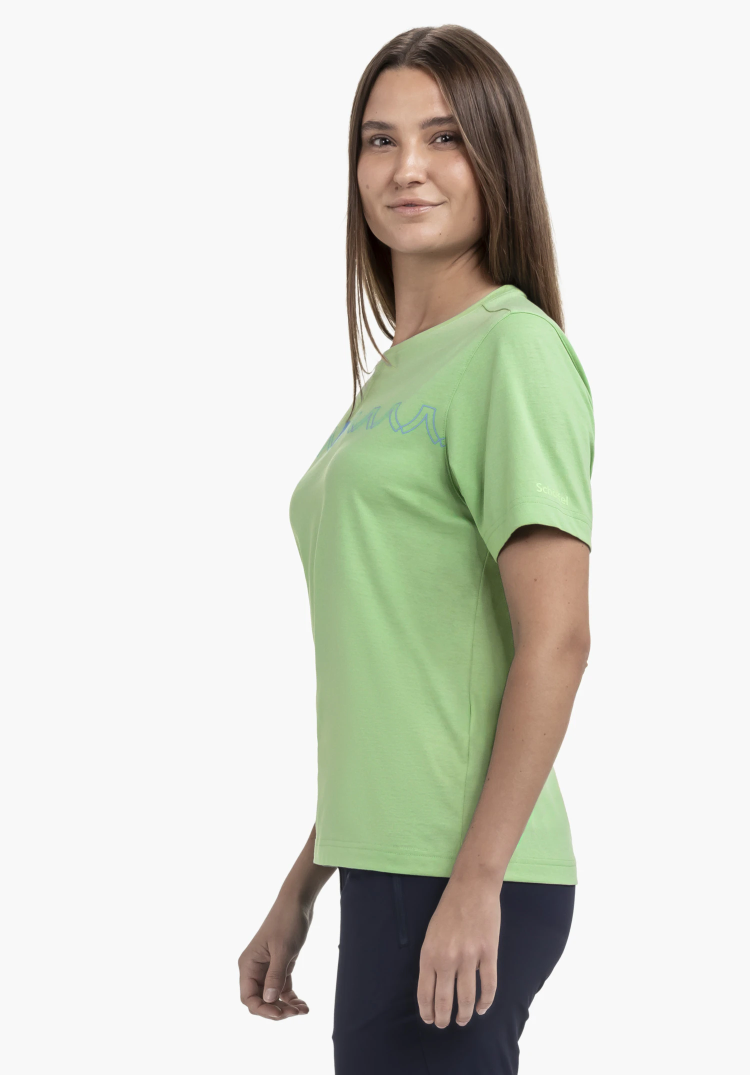 T Shirt Style Elmori WMN in green, shown from a side perspective on a model against a neutral background. The subtle chest print and the distinctive Schöffel logo on the sleeve emphasize the sporty look.