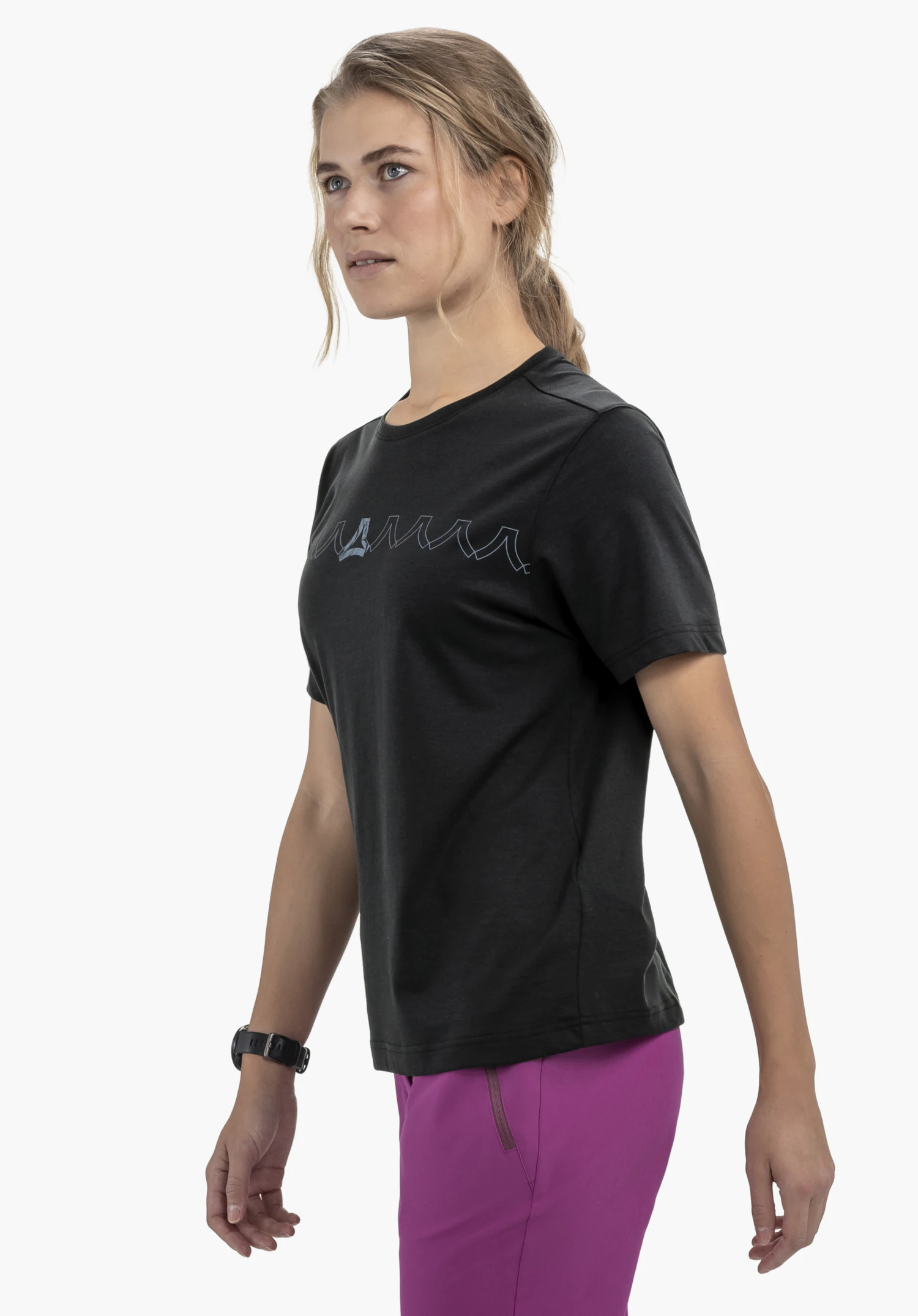 T Shirt Style Elmori WMN in black, worn by a model standing in a side-profile position against a neutral background. The tee features a modern fit and clearly displays the Schöffel logo on the chest.