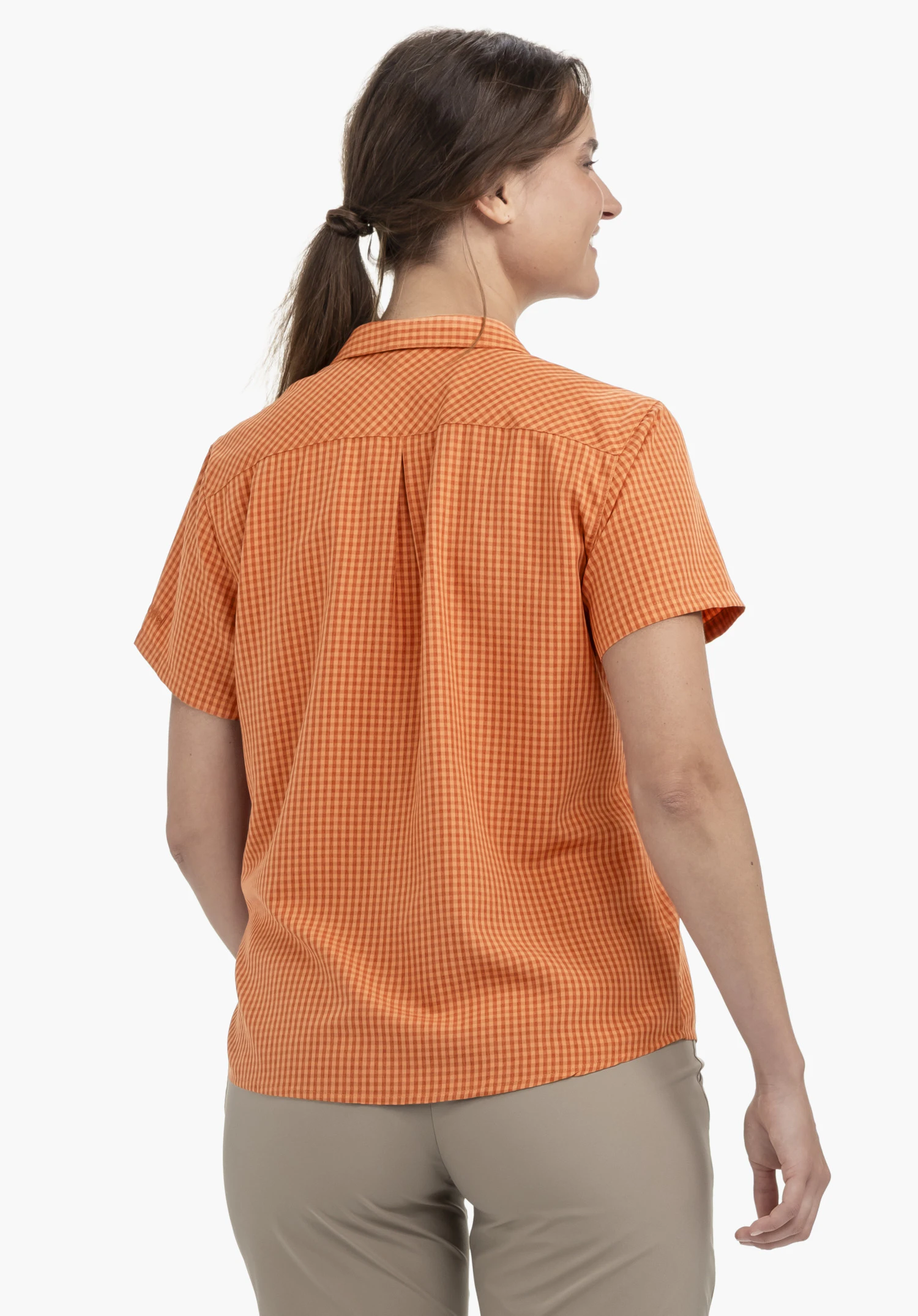 CIRC Blouse Style Dalfoss WMN : Vue de dos d'une femme portant le chemisier orange vif. Le mannequin se tient devant un fond neutre et laisse entrevoir le logo Schöffel discret sur la manche.