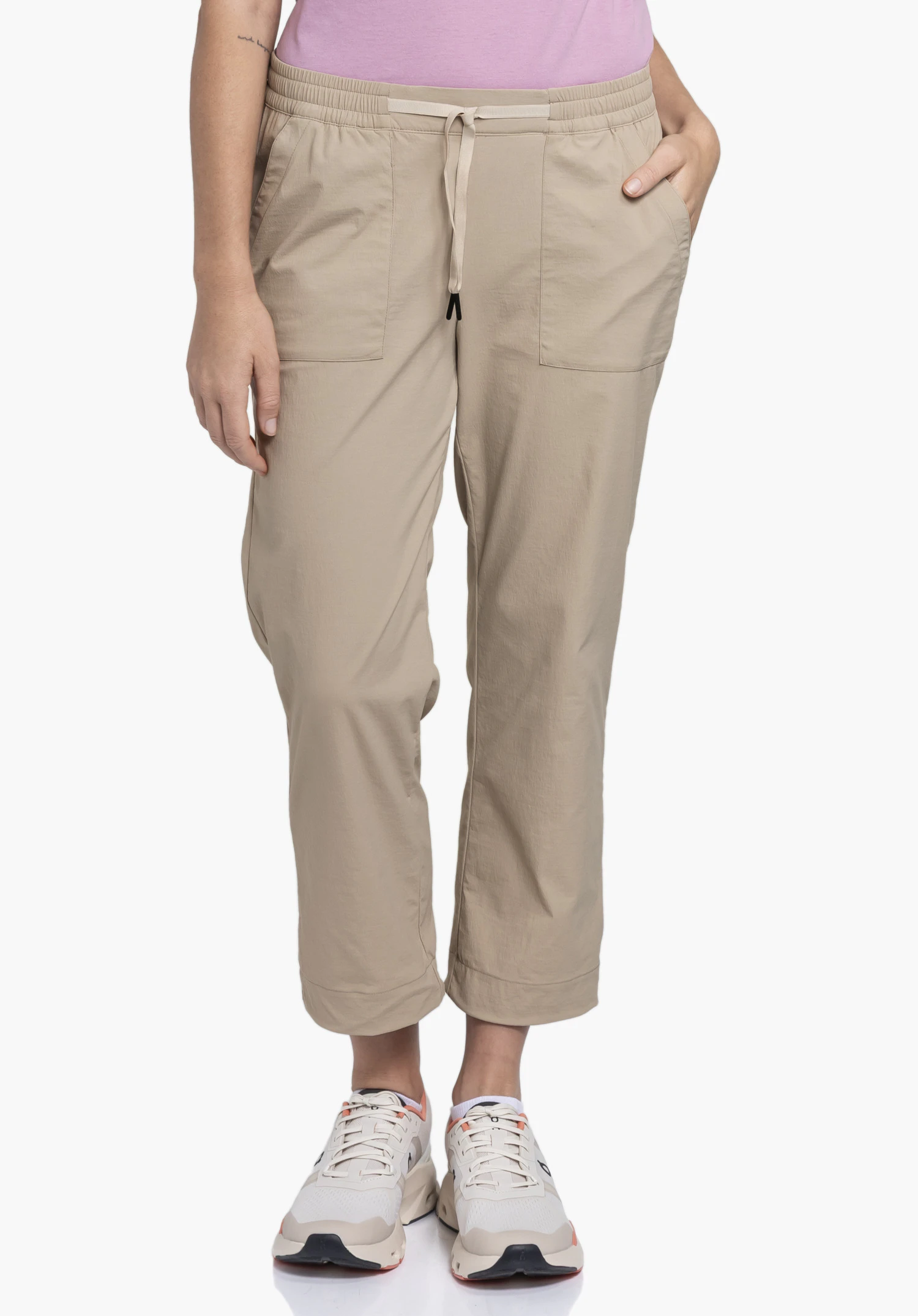 Pants Rangun L in the colour beige on a model standing frontally against a neutral background with one hand in the trouser pocket.