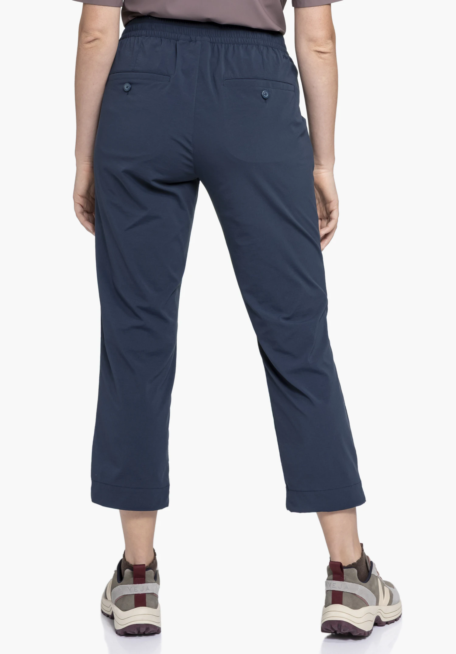 Pants Rangun L in blue in a rear view on a model against a neutral background with a visible Schöffel logo and back pockets.