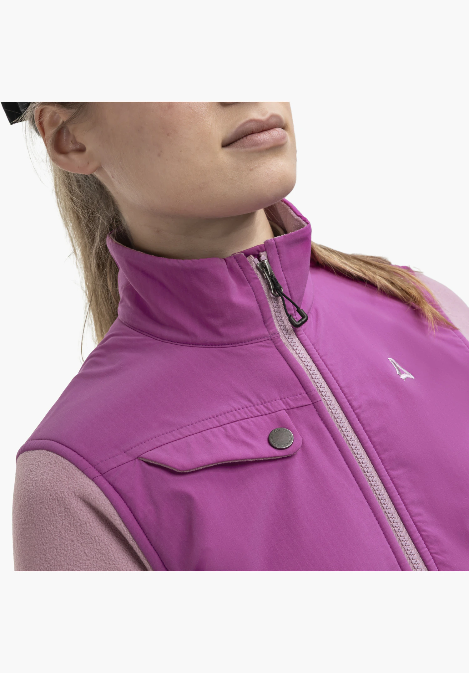 Fleece Jk Style Maghera WMN in pink, focusing on the stand-up collar, the partially opened front zip with pull tab, the chest pocket with popper fastening, and the white Schöffel logo on the smooth fabric panel contrasting with the fleece material, as a close-up against a white/neutral background.