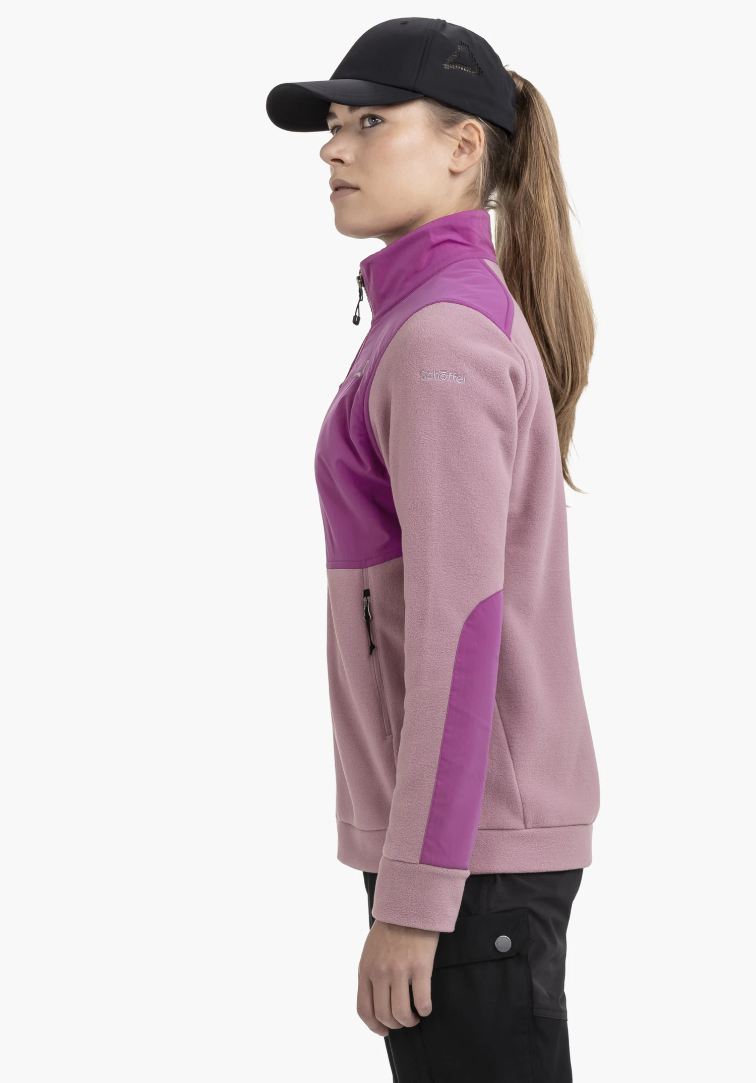 Fleece Jk Style Maghera WMN is shown in a side profile against a neutral background. The model is wearing the jacket in a pink colourway, showcasing the subtle Schöffel logo on the upper arm.