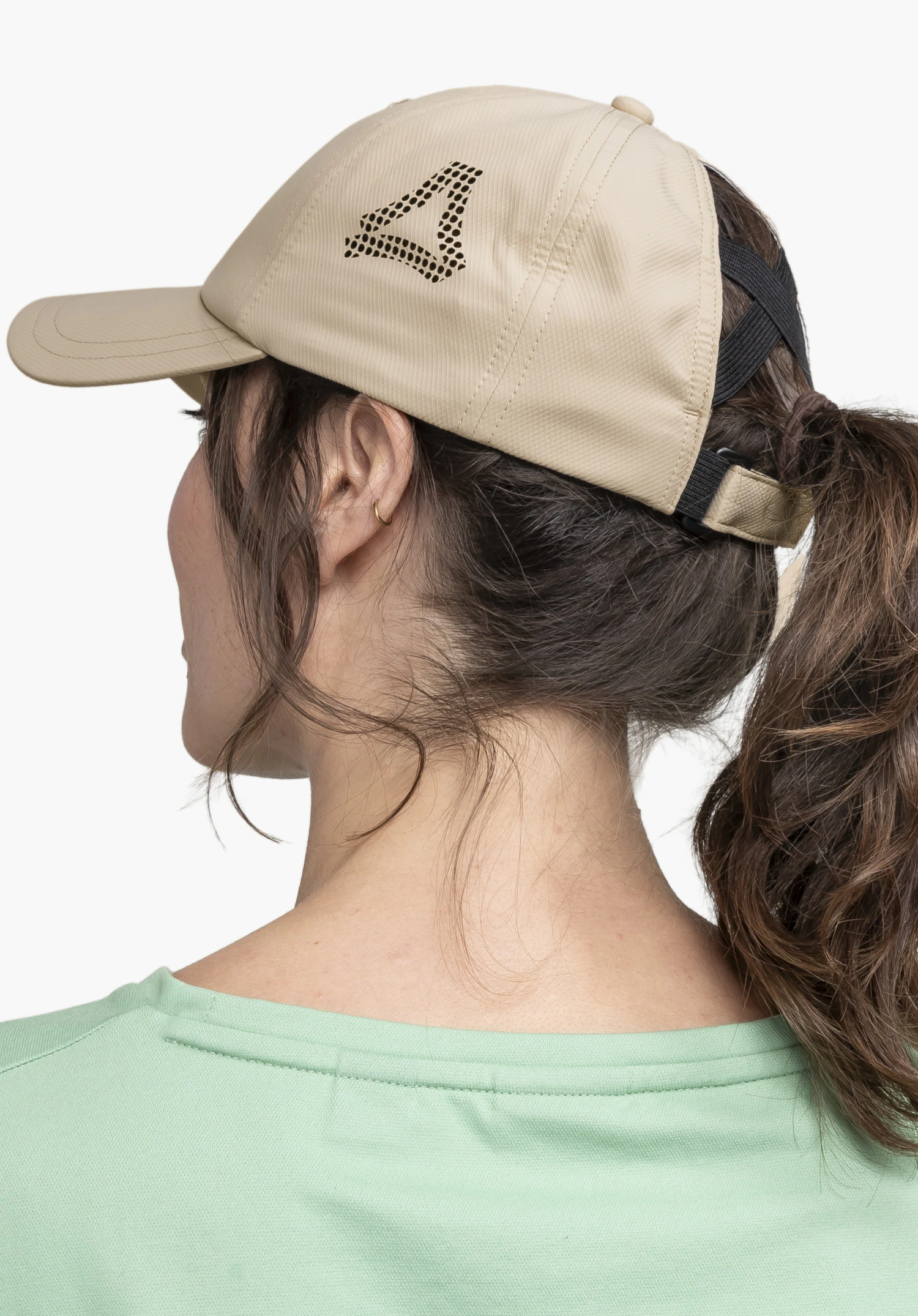Cap Style Migandi WMN in beige shown on a model from a half-back perspective against a neutral background. The perforated Schöffel logo is visible on the side of the cap.