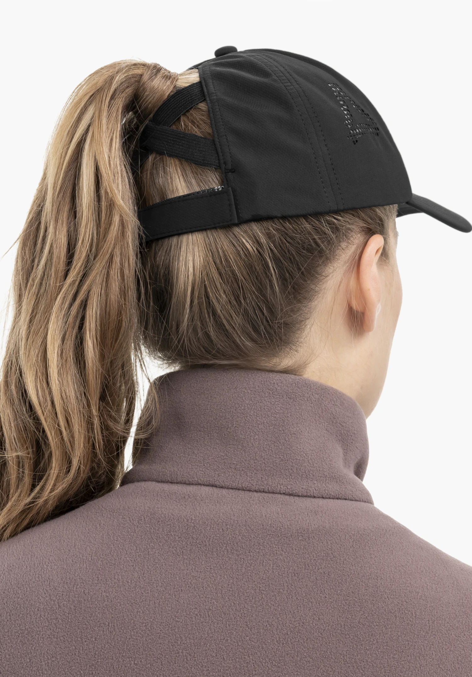 Cap Style Migandi WMN in black, seen from behind. The model wears the cap against a neutral background, highlighting the special ponytail opening and the subtle Schöffel logo on the side.