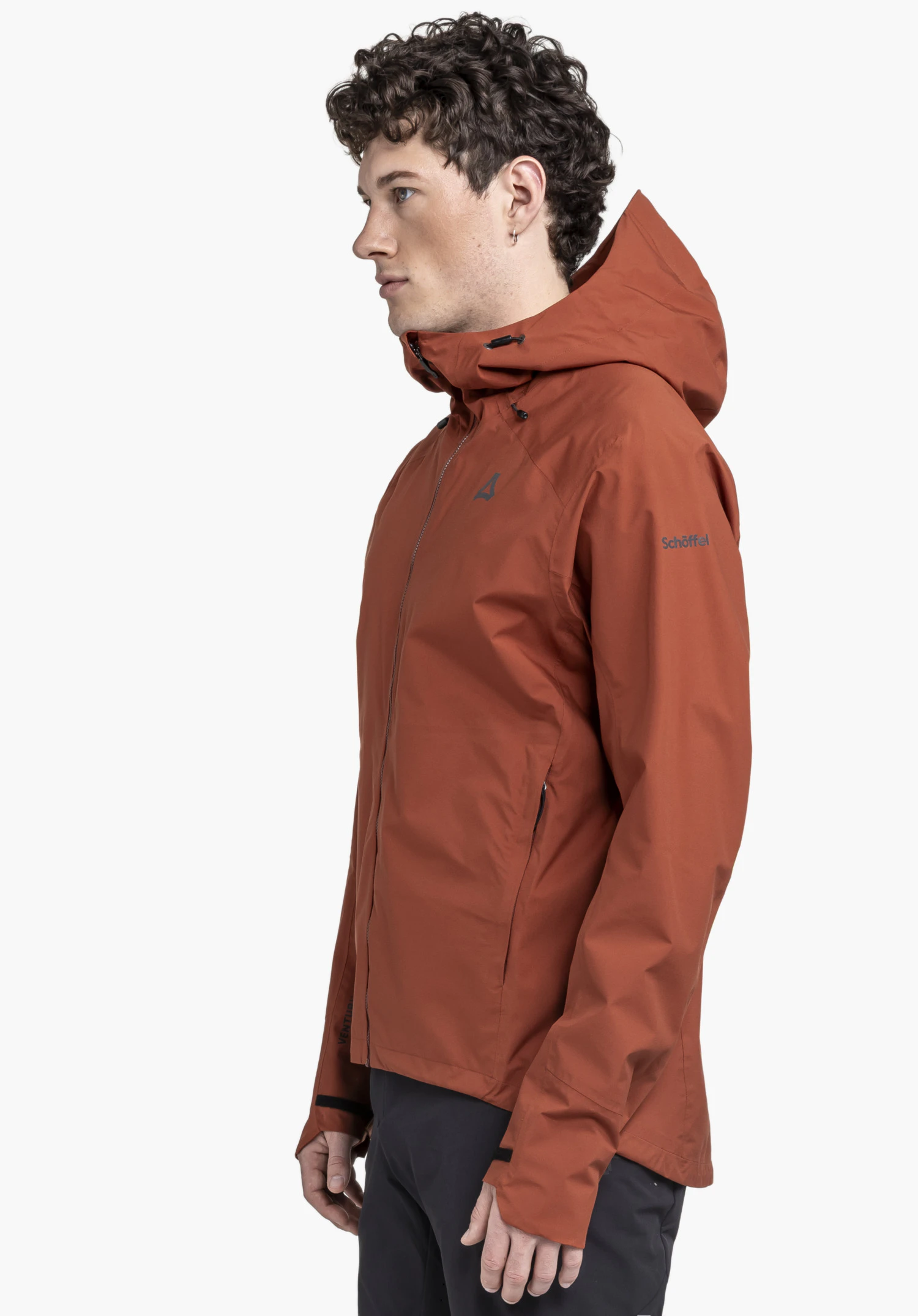 2.5L Jacket Style Tajiva MEN in red: A model stands sideways against a neutral background, showcasing the jacket with hood. The Schöffel logo is subtly visible on the chest and sleeve.