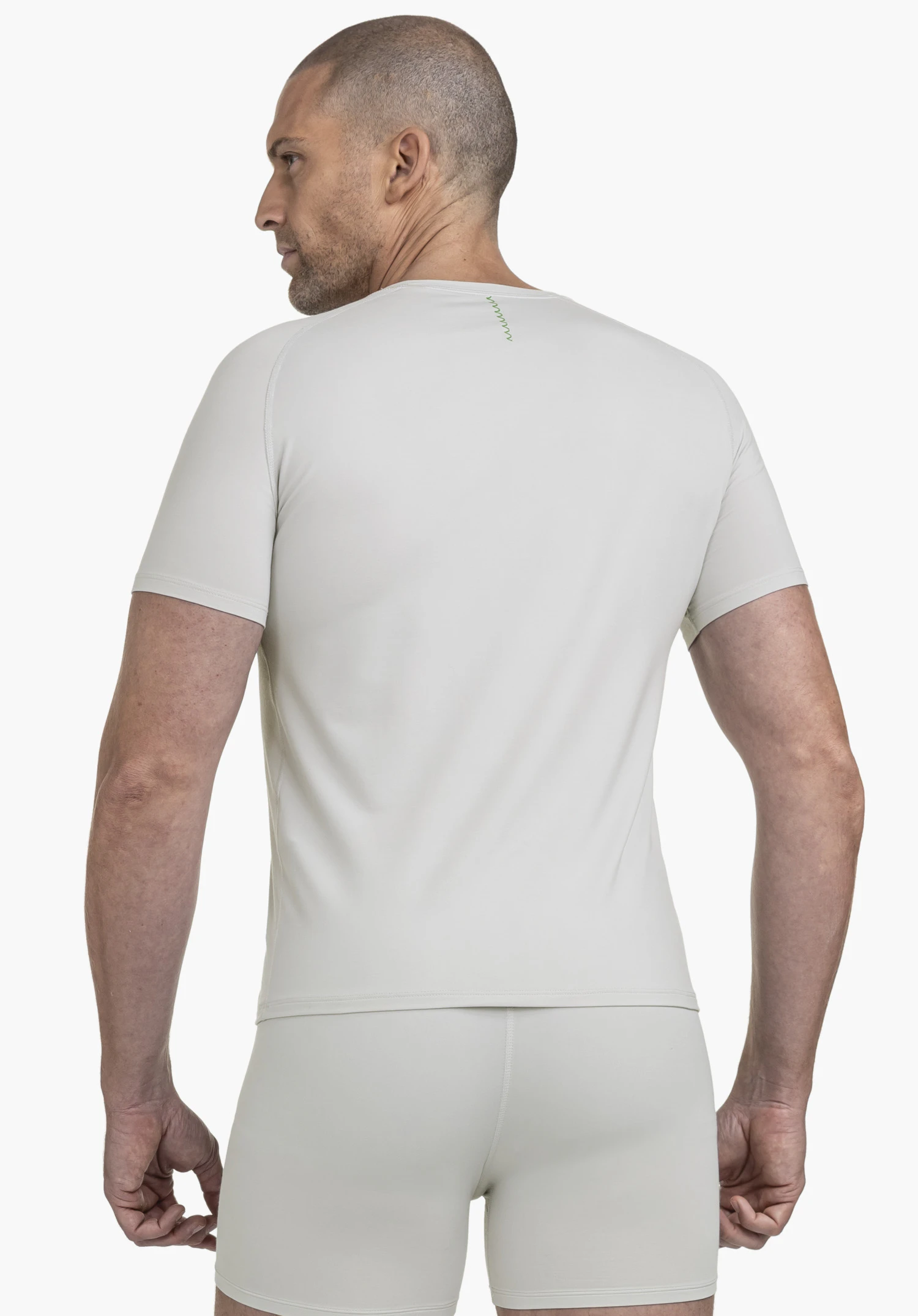 T Shirt Style Konera MEN shows a model from the rear view wearing a grey functional shirt with a subtle Schöffel logo at the neck against a neutral background.