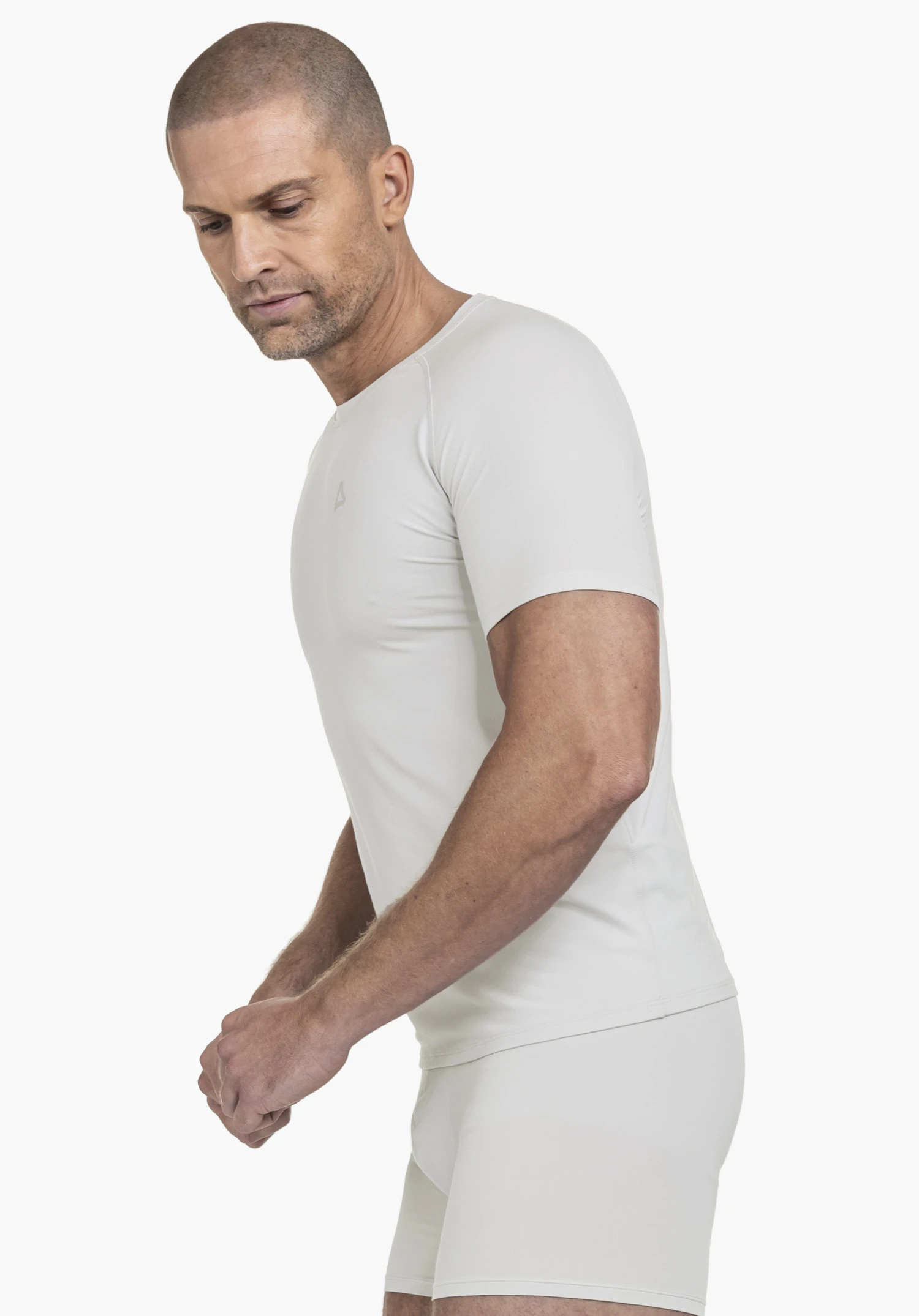 T Shirt Style Konera MEN in grey shown on a male model posed in profile against a neutral background, highlighting the subtle Schöffel logo on the chest.