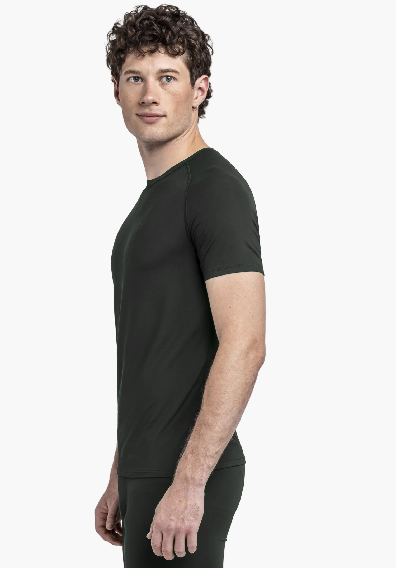 T Shirt Style Konera MEN in black. The model stands sideways against a neutral background, showcasing the short-sleeved design. The subtle Schöffel logo on the chest completes the clean look for athletic activities.