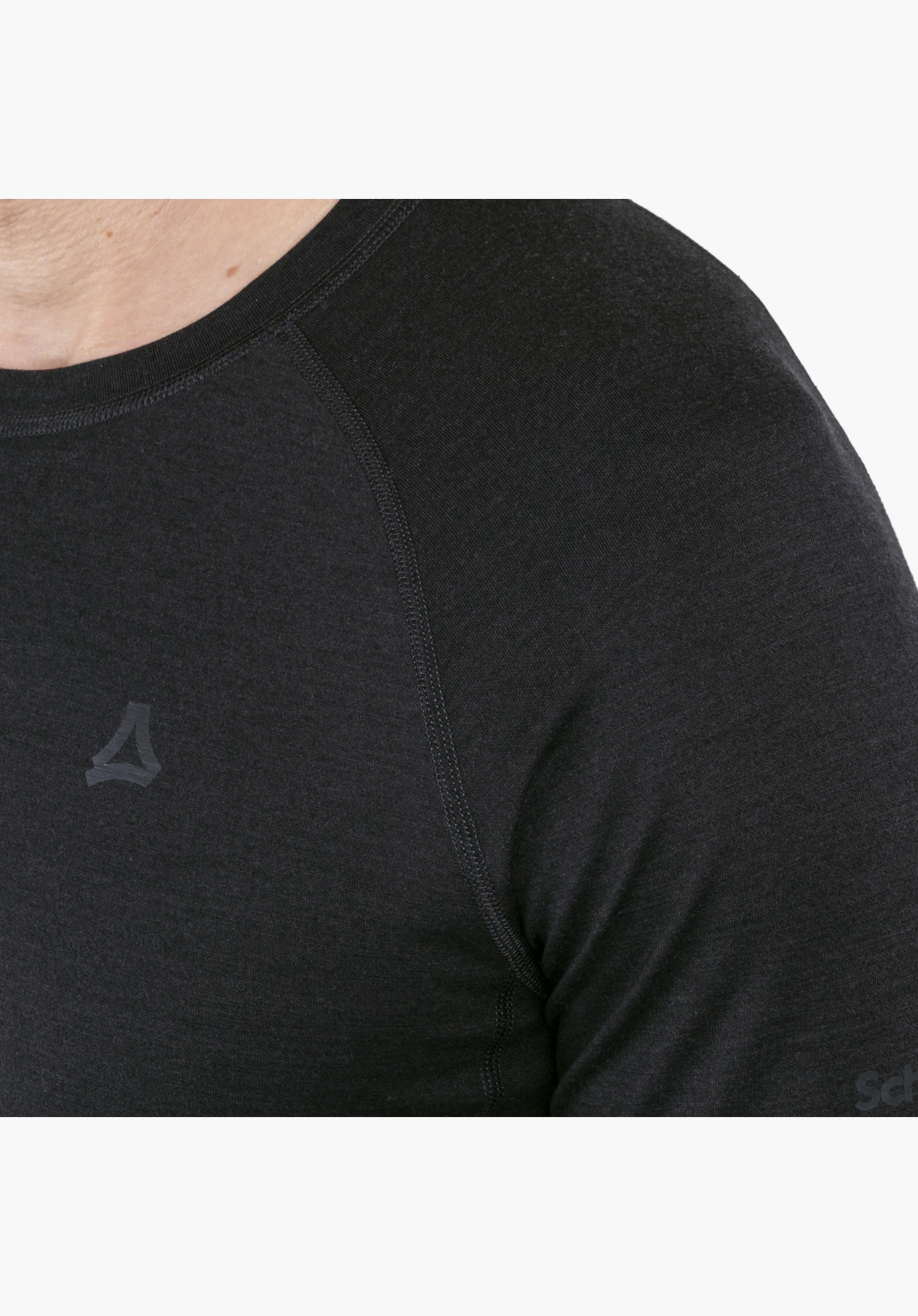 Longsleeve Style Luterra MEN in black focusing on the shoulder area, the crew neck, the subtle Schöffel logo at the bottom left, and the textured material surface in a close-up against a white background.