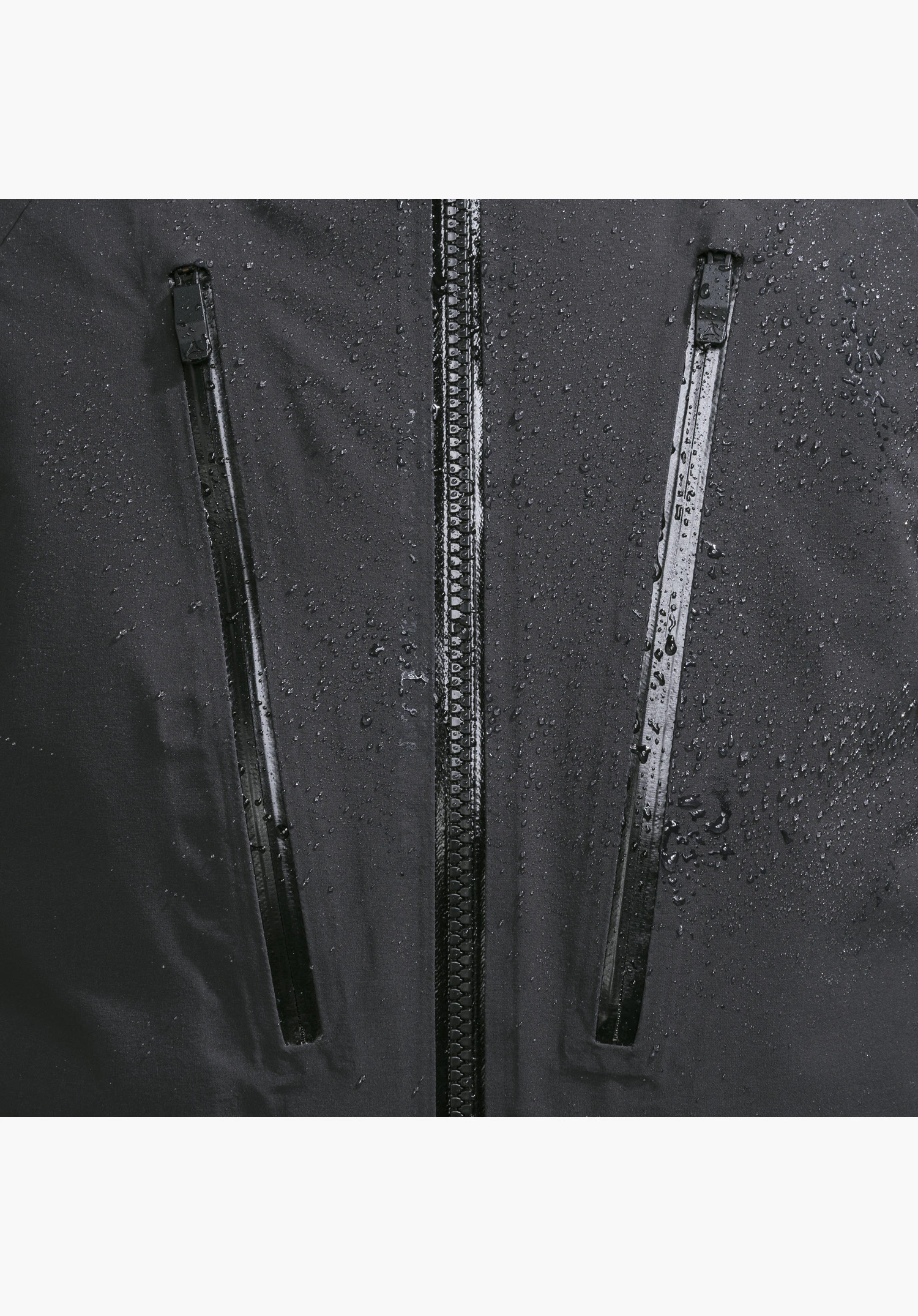 Jacket Style Radiana MEN in black featuring water-repellent zippers and raindrops on the fabric close-up against a white background.