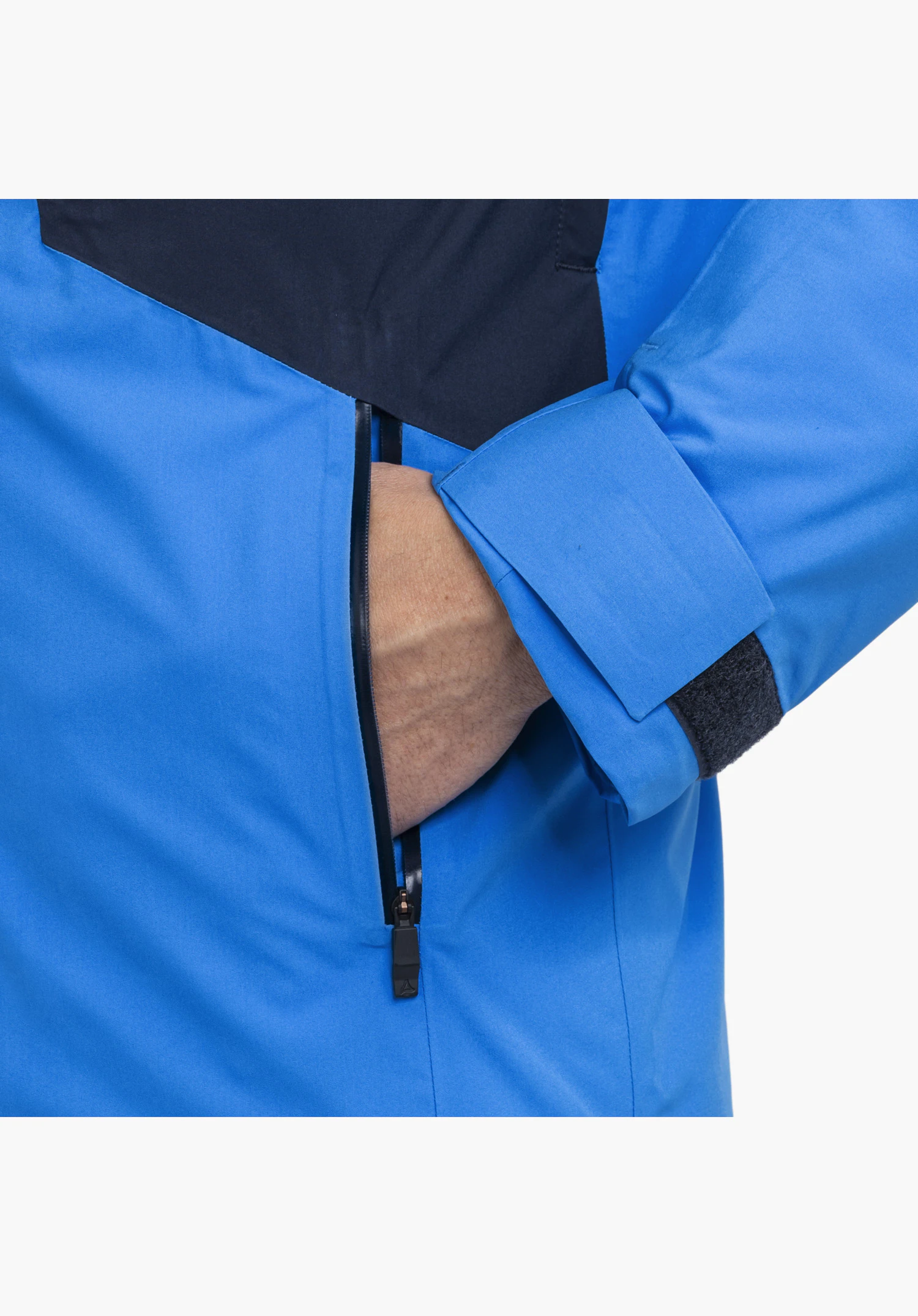 Jacket Style Trifex MEN in blue with a focus on the water-resistant zipped pocket and the adjustable cuff with Velcro fastening close-up against a white background.