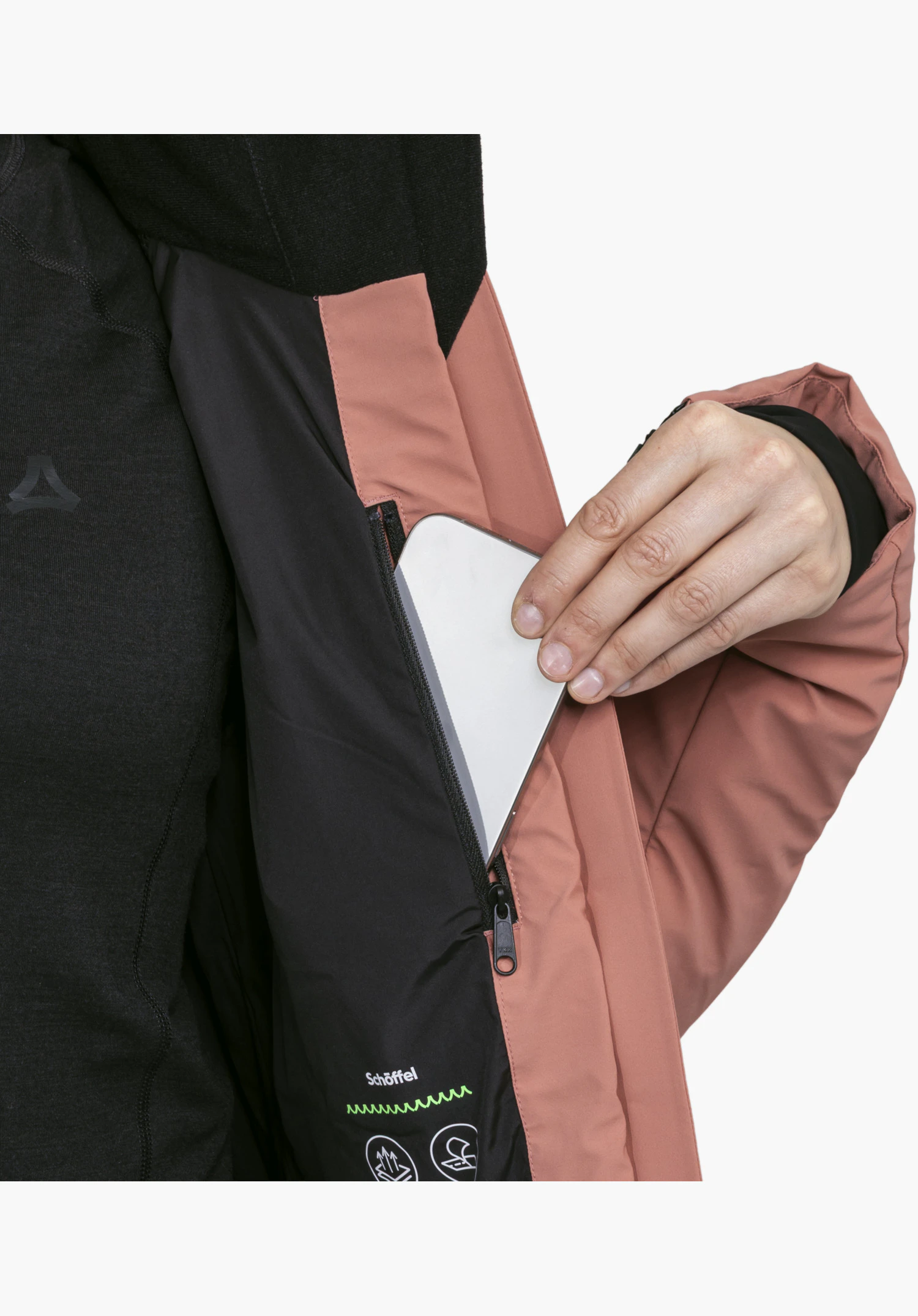 Jacket Style Caldirola WMN présentant l'intérieur rose et une main glissant un smartphone dans la poche intérieure lors d'un gros plan sur fond blanc.