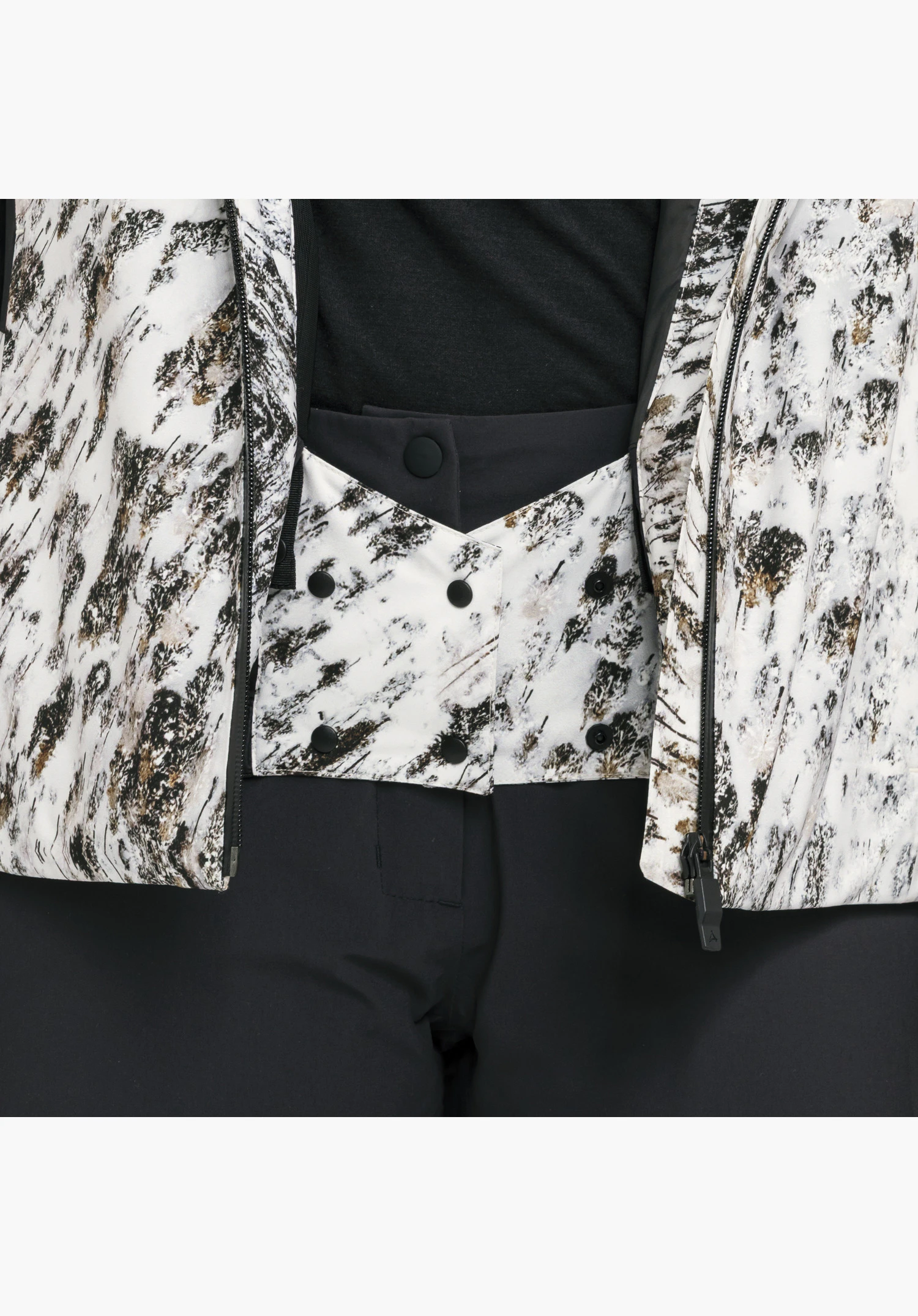 Schöffel X Tom Hegen JK WMN avec jupe pare-neige intégrée de couleur natur avec imprimé noir et blanc en gros plan sur fond neutre.