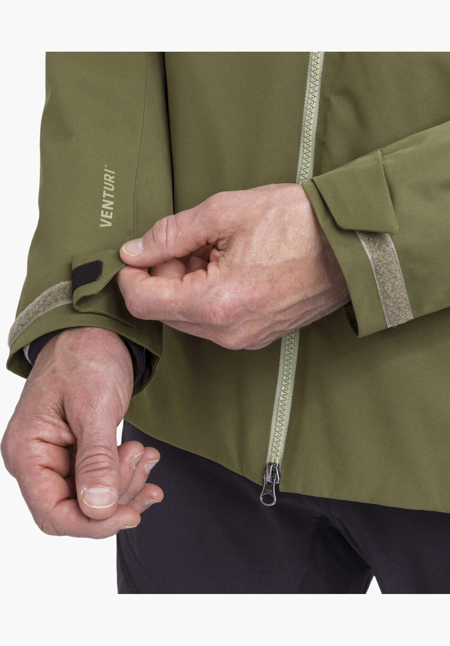Jacket Style Yew MEN in green showing a close-up of the adjustable cuff with Velcro fastening and printed Venturi lettering as well as the two-way front zipper in a close-up against a white background.