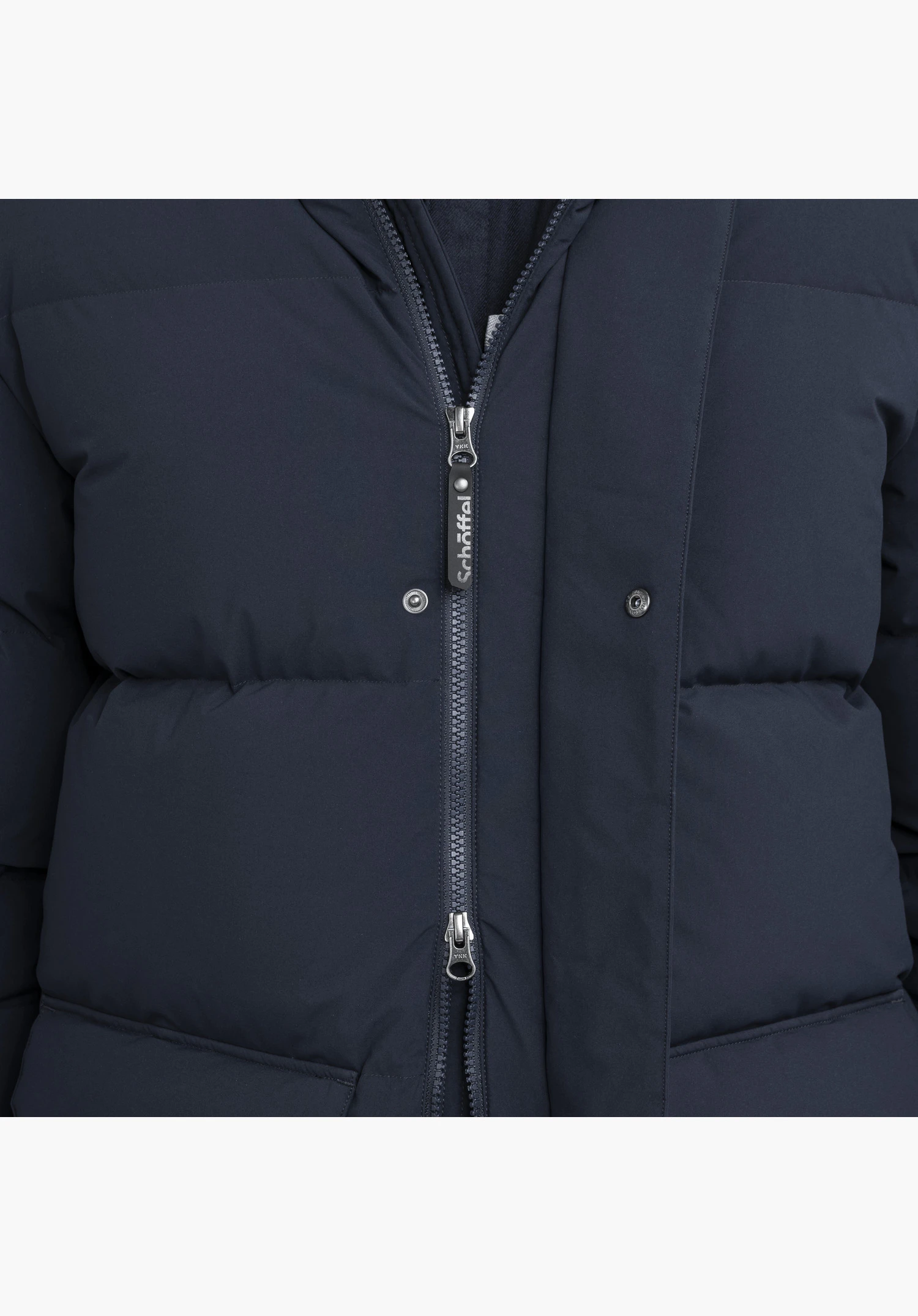 Down Parka Style Vindave MEN in blue showing the front zipper with a Schöffel lettering on the puller and snap buttons in the upper section in a close-up against a white background.