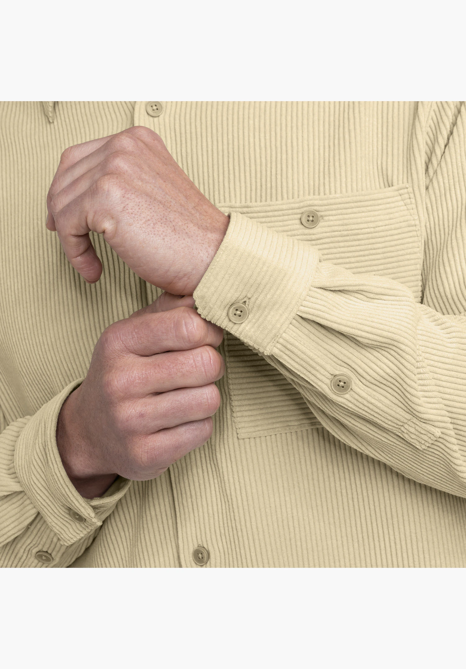 Shirt Style Libereo MEN in beige focusing on the cuff and the fine rib-corduroy texture of the material close-up shot against a white background.