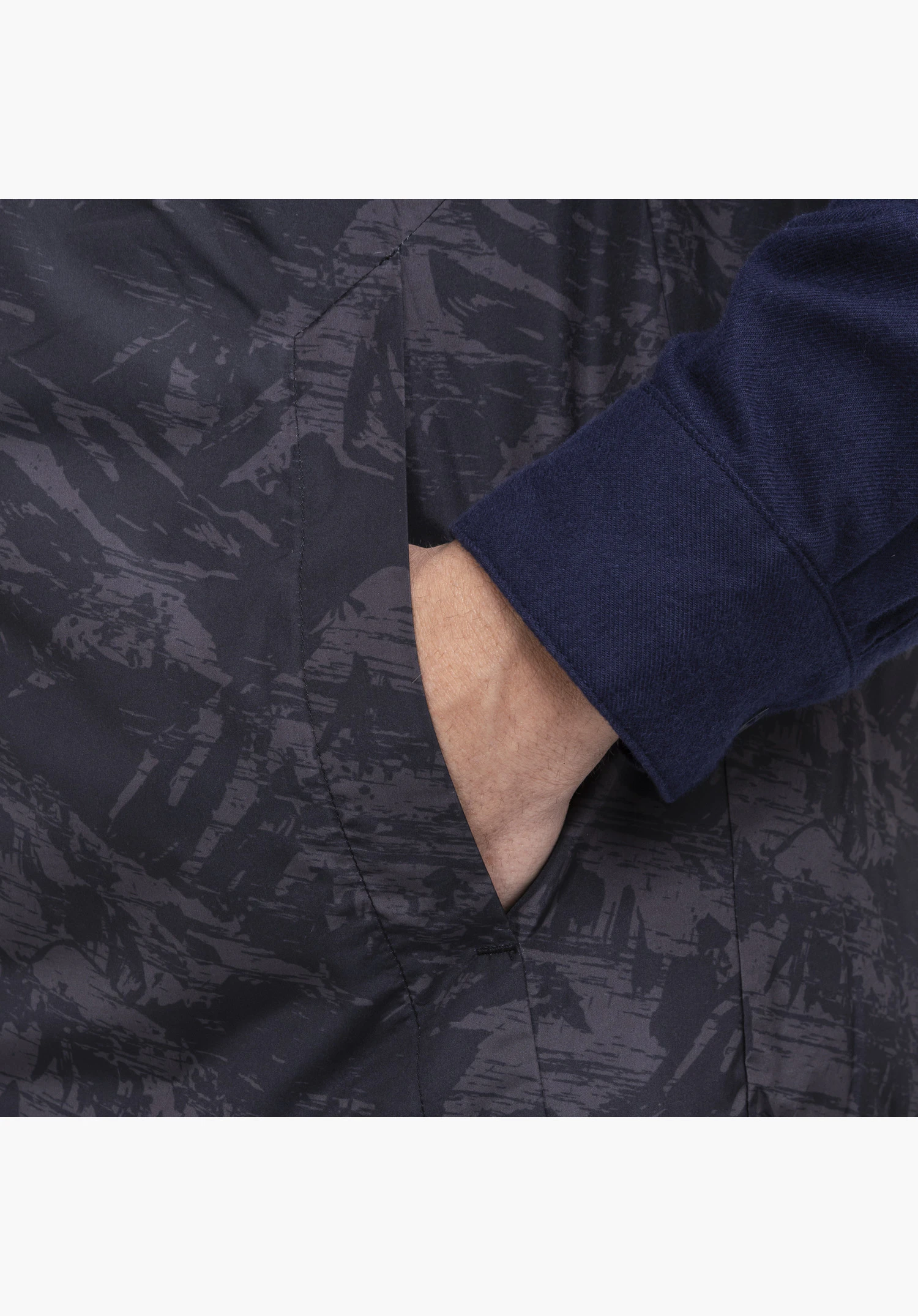 Vest Style Purga MEN featuring a practical side pocket and patterned fabric in green, close-up against a white background.